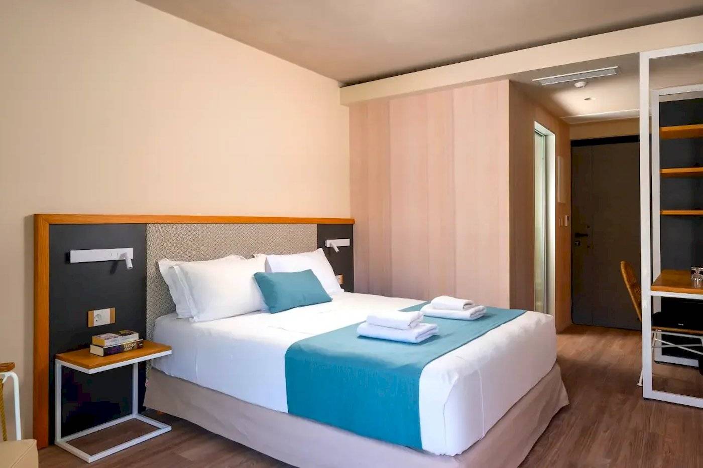 Innenansicht eines Zimmers im Corissia Beach Hotel mit Bett, Nachttischen und Schrank