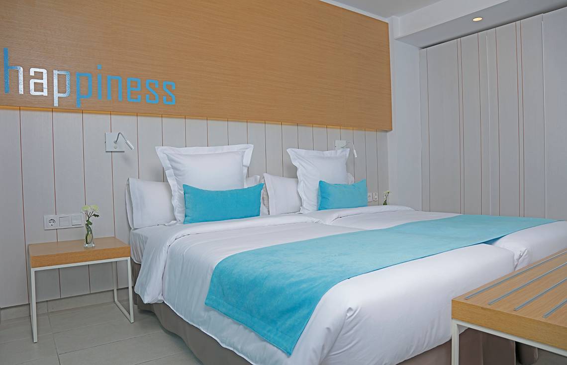 Doppelbettzimmer im LABRANDA Bronze Playa Hotel mit 'happiness' Wanddekoration.