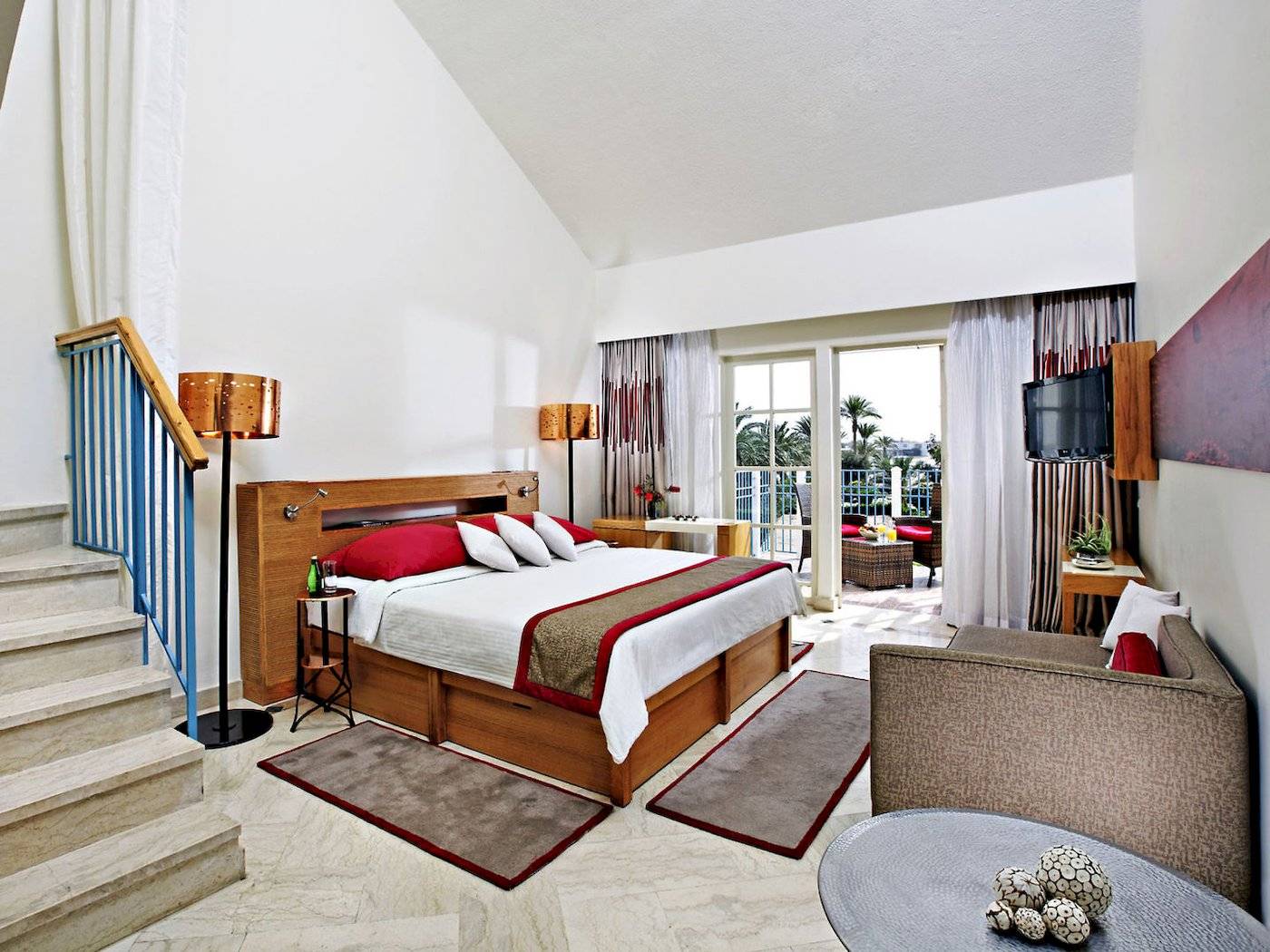 Hotelzimmer im Mövenpick Resort & Spa El Gouna mit Bett, Sofa, Tisch und Balkon