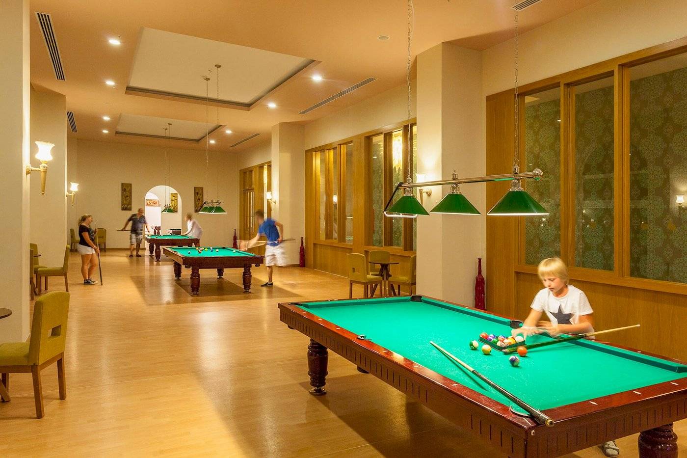 Billardtisch im Defne Defnem Hotel mit mehreren Spielern und Besuchern.
