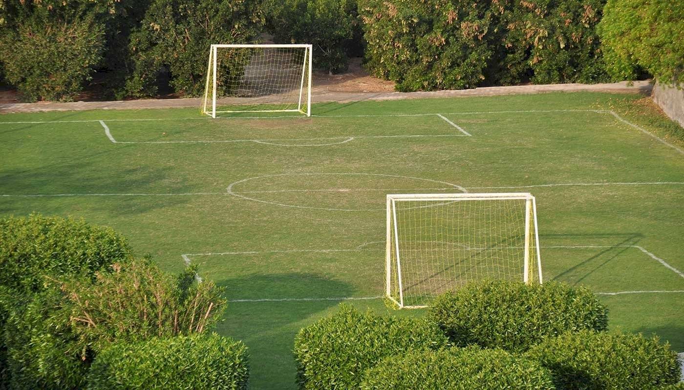 Fussballfeld im Brayka Bay Resort mit zwei Toren und umsaenumten Spielflaechen.