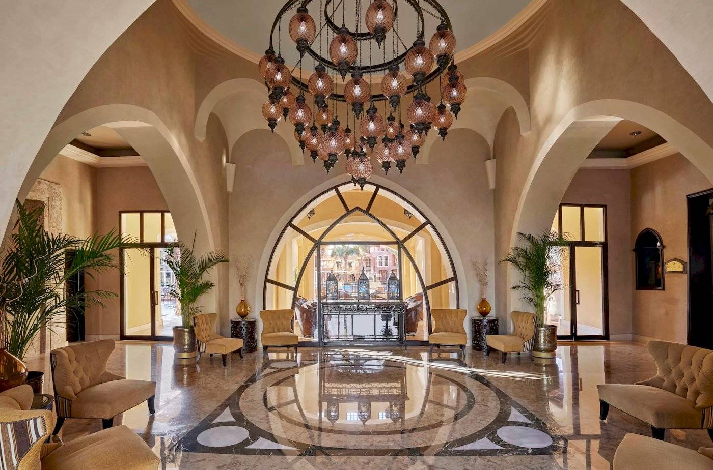 Hotellobby des JAZ Neo Dar El Madina mit einem großen Kronleuchter und Möbeln