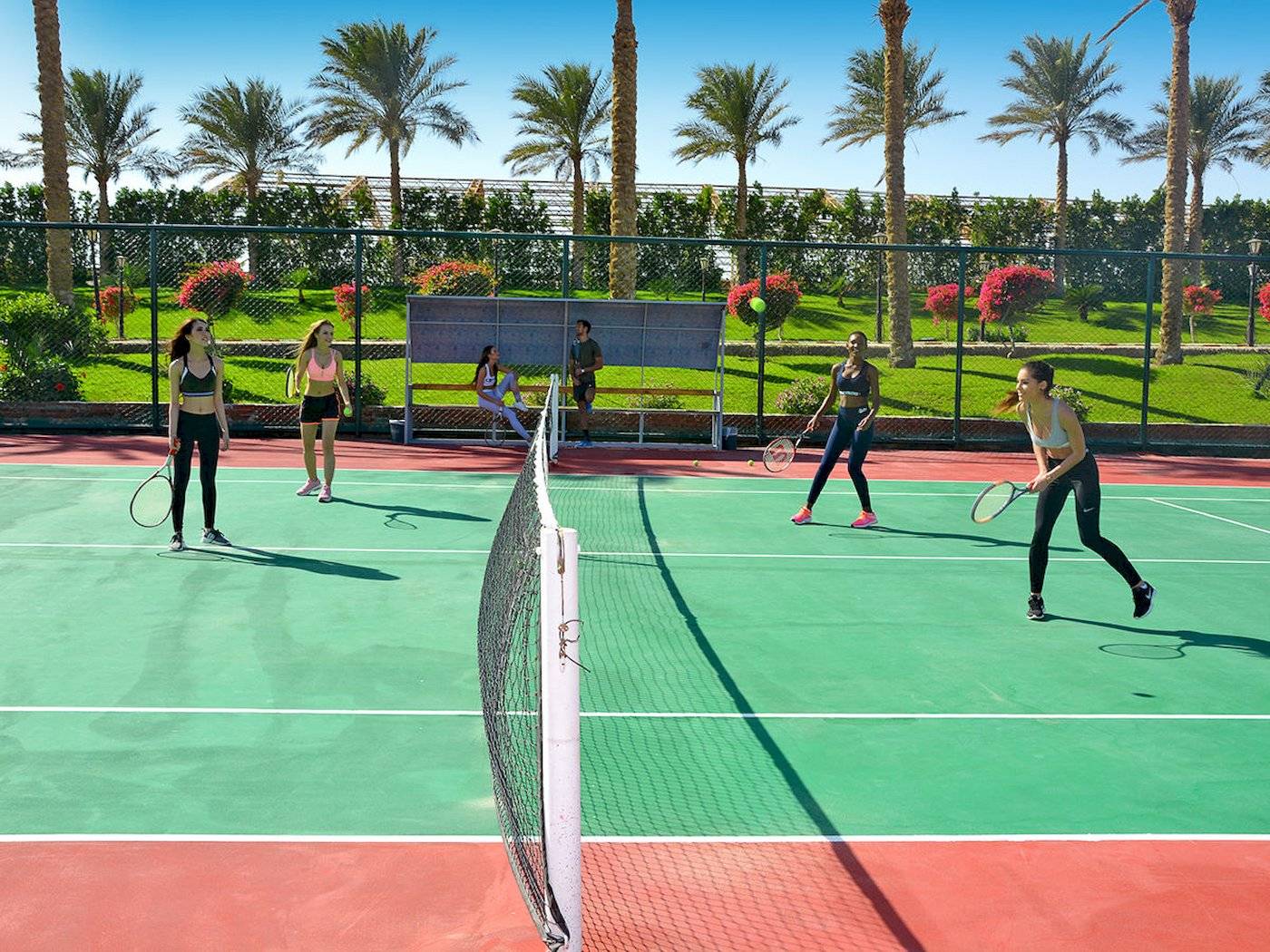 Tennisspiel im Sunrise Royal Makadi Resort mit Spielern und Zuschauern im Freien.
