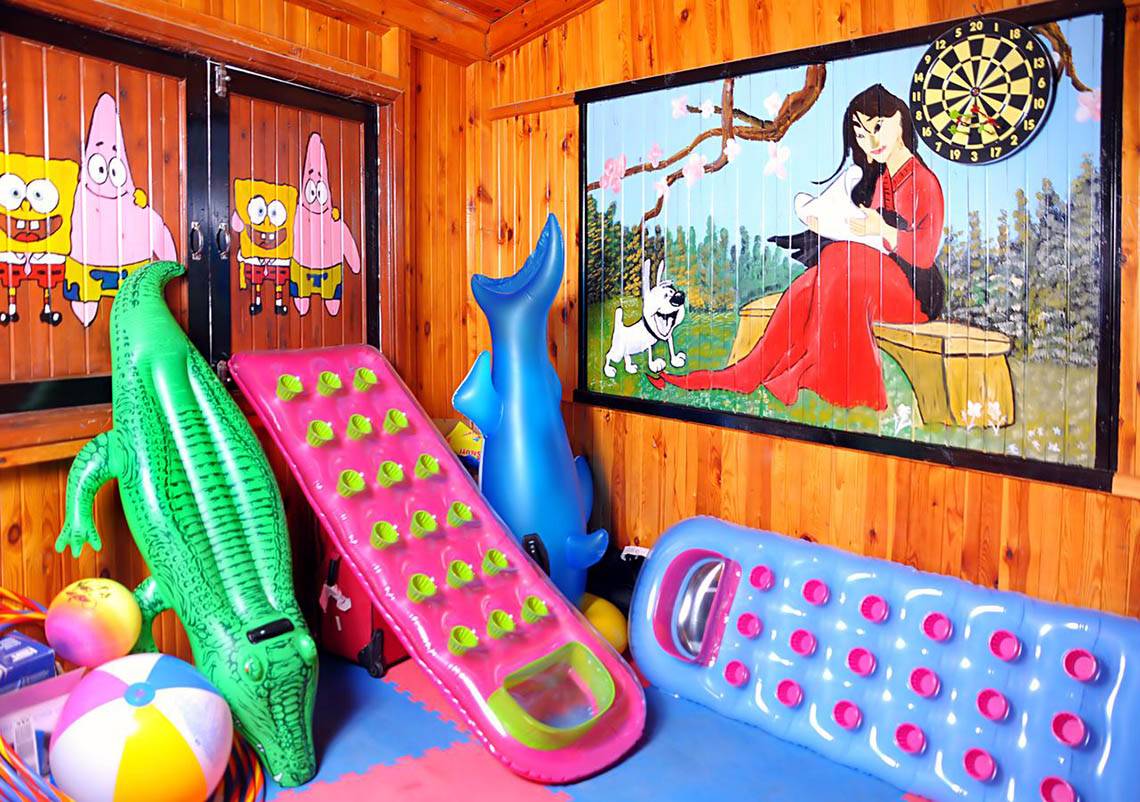 Spielzimmer im Hotel Pharaoh Azur mit aufblasbaren Spielzeugen und Dartscheibe.