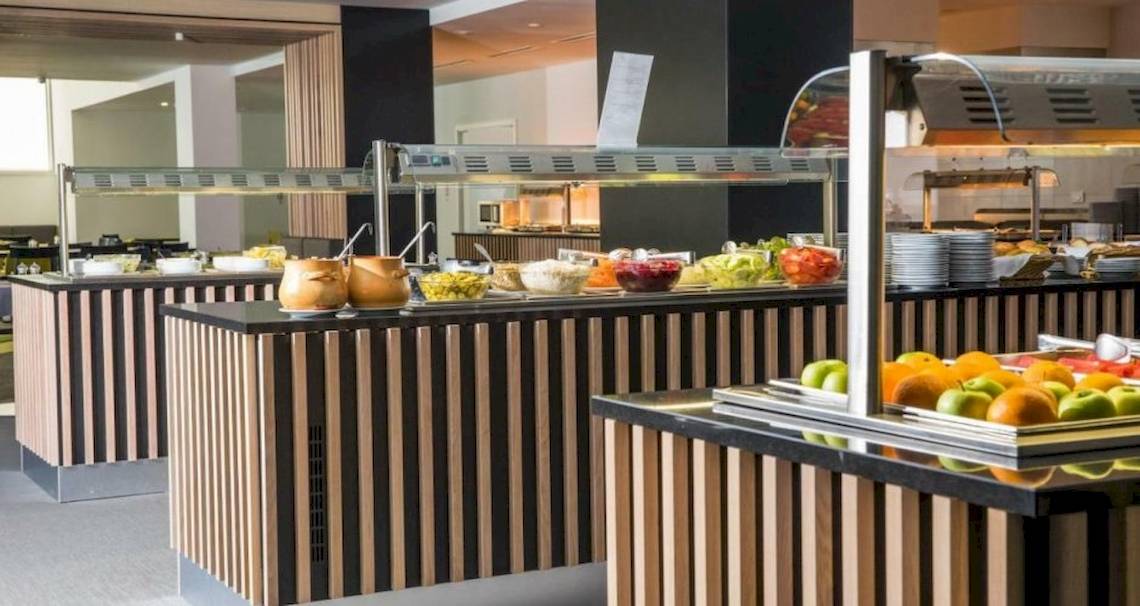 Buffetbereich im Osmine Slano Hotel mit verschiedenen Speisen und Früchten.