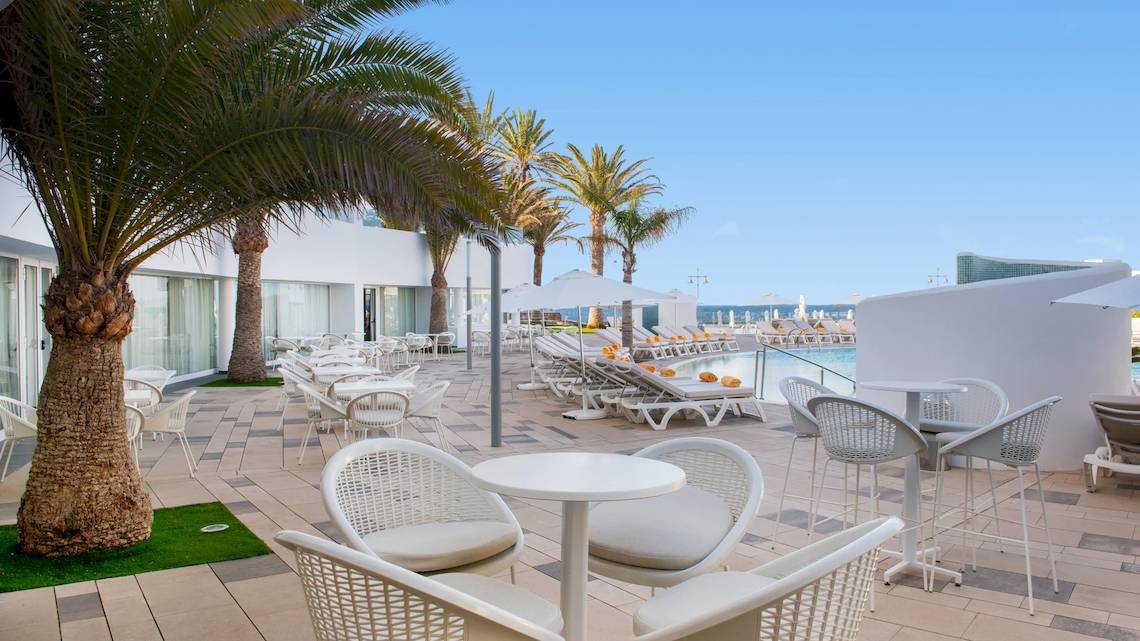 Außenbereich des Iberostar Selection Lanzarote Park Hotels mit Loungestühlen und Tischen neben dem Pool
