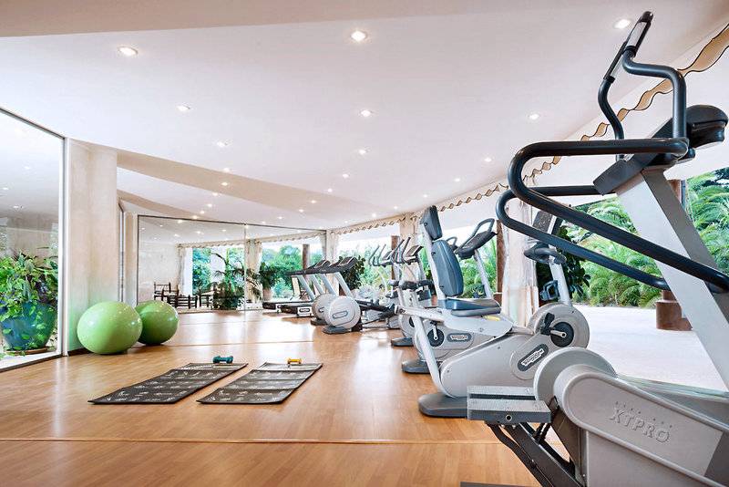 Fitnessstudio im Marinedda Hotel Thalasso & Spa mit Cardiogeräten und Yogamatten