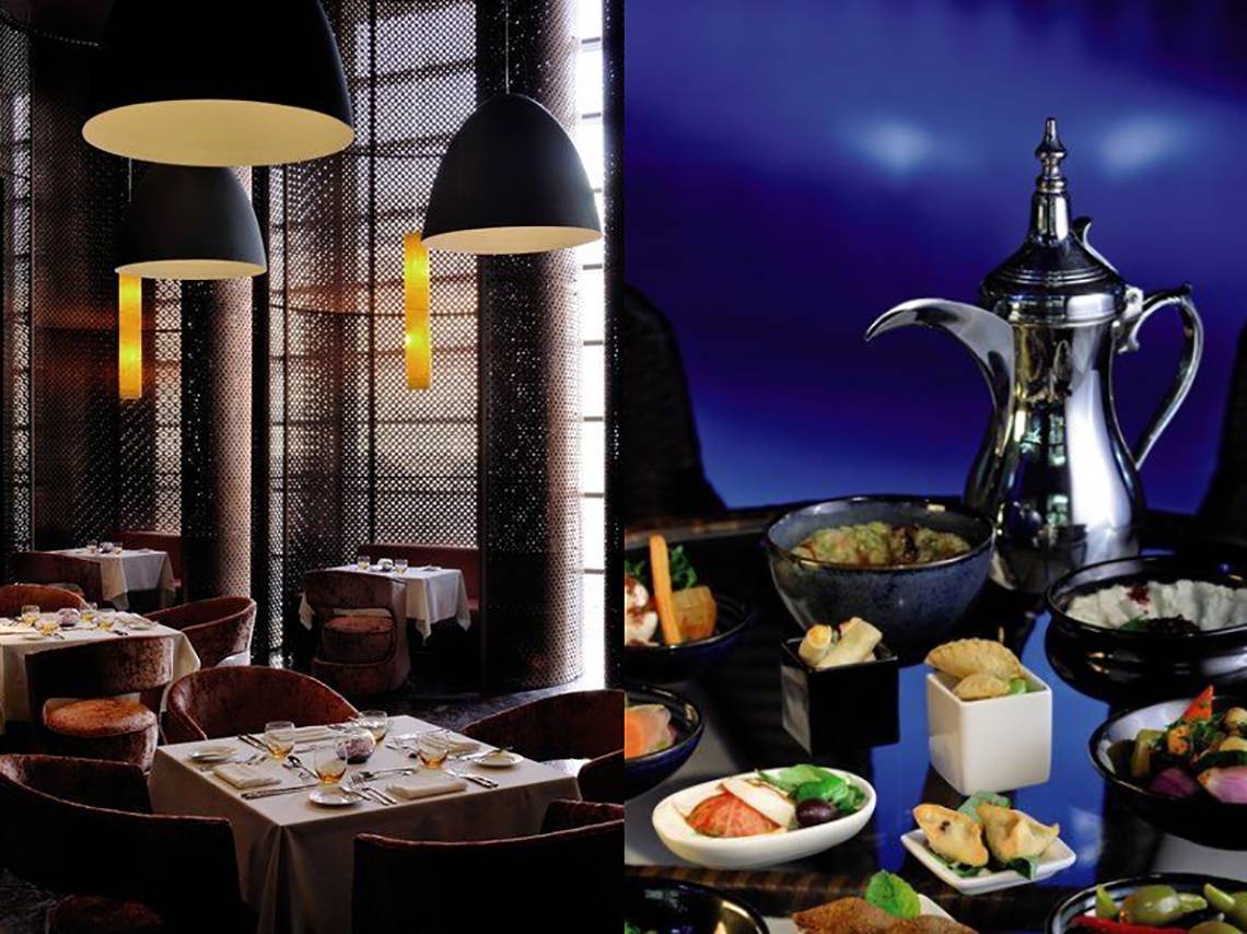 Restaurant des Southern Sun Abu Dhabi mit Tischen und Speisen im Vordergrund, eine Karaffe im Hintergrund.