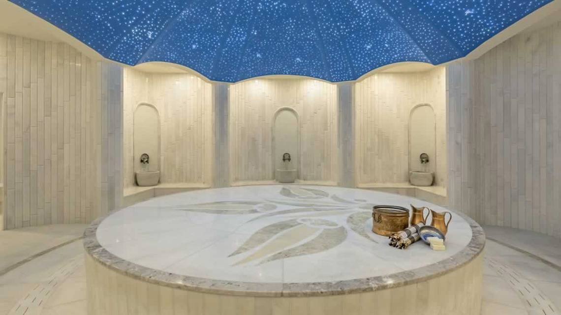 Innenansicht des Spas im Royal Seginus Hotel mit runden Marmortisch und Sternenhimmel.