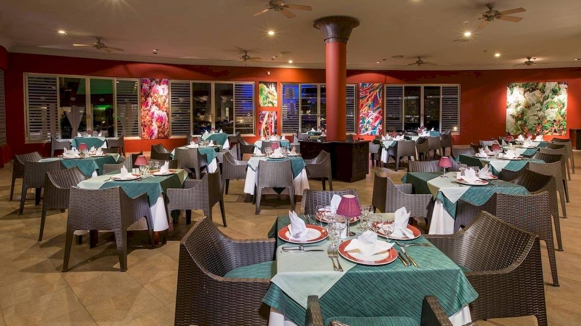 Restaurant im Grand Sirenis Riviera Maya Resort & Spa mit eingerichteten Tischen und Stühlen.