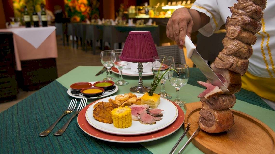 Ein Gericht wird im Grand Sirenis Riviera Maya Resort & Spa serviert, mit Steaks, Mais und Beilagen auf einem Teller.