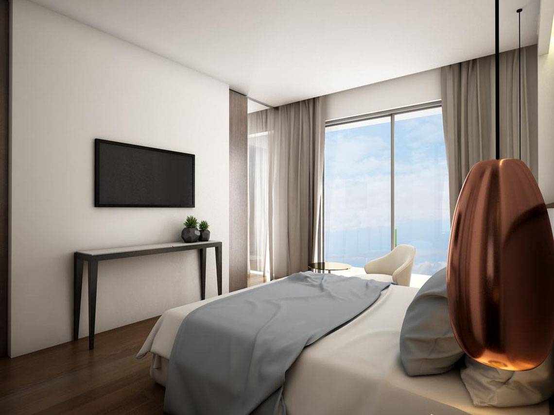 Schlafzimmer im NissiBlu Beach Resort mit Meerblick, Flachbildfernseher, Konsole und Lampe
