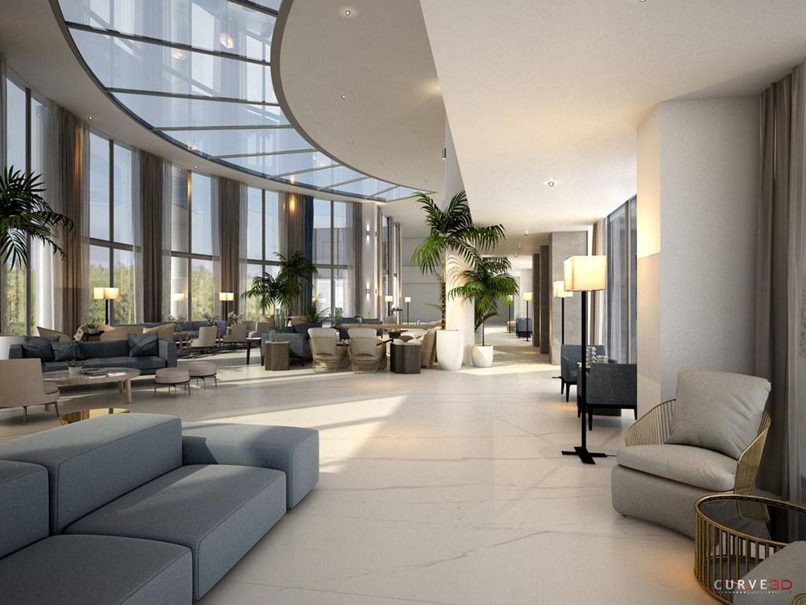 Innenansicht der Lobby des NissiBlu Beach Resort mit großen Fenstern und modernen Möbeln.