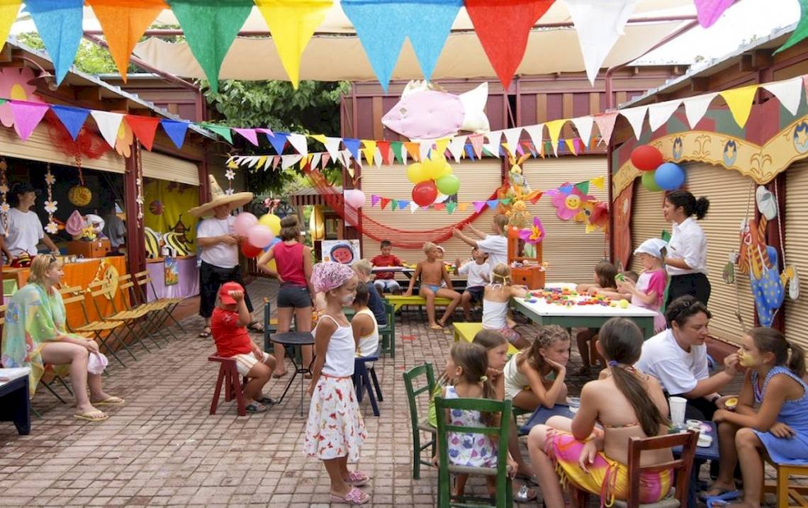 Kinderfest im Freien mit bunten Flaggen und Luftballons im Aquila Rithymna Beach Hotel.