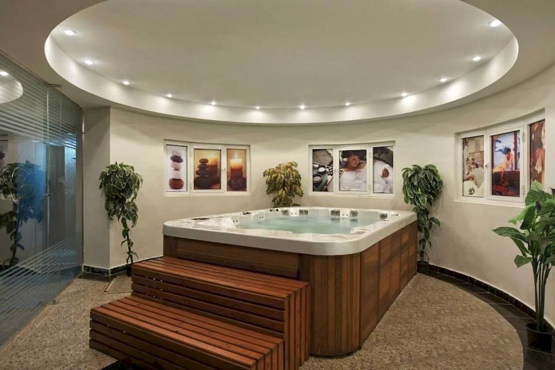 Jacuzzi im Hurghada Long Beach Resort mit Pflanzen und dekorativen Bildern an der Wand.