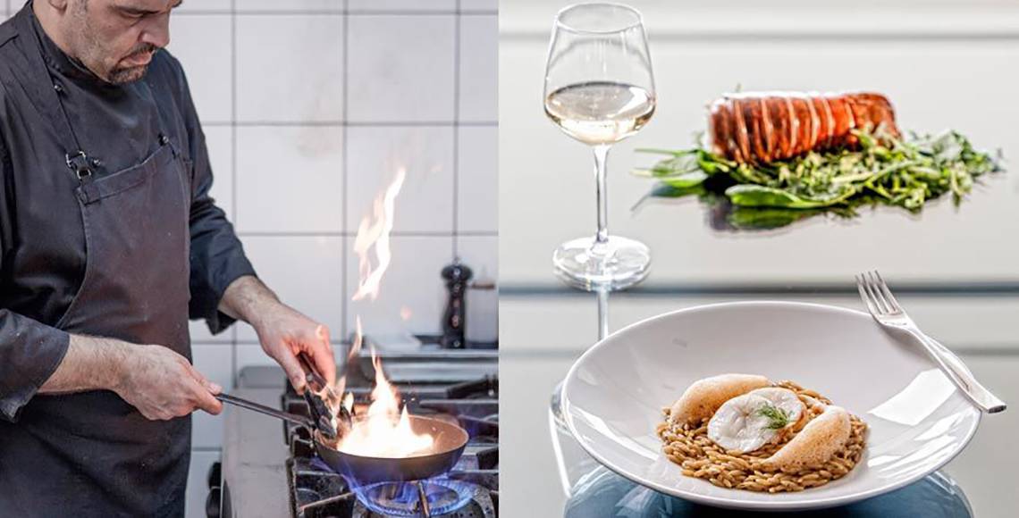 Ein Glas Weißwein und ein Gericht mit Hummer und Beilagen auf einem Tisch im Aqua Blu Boutique Hotel & Spa