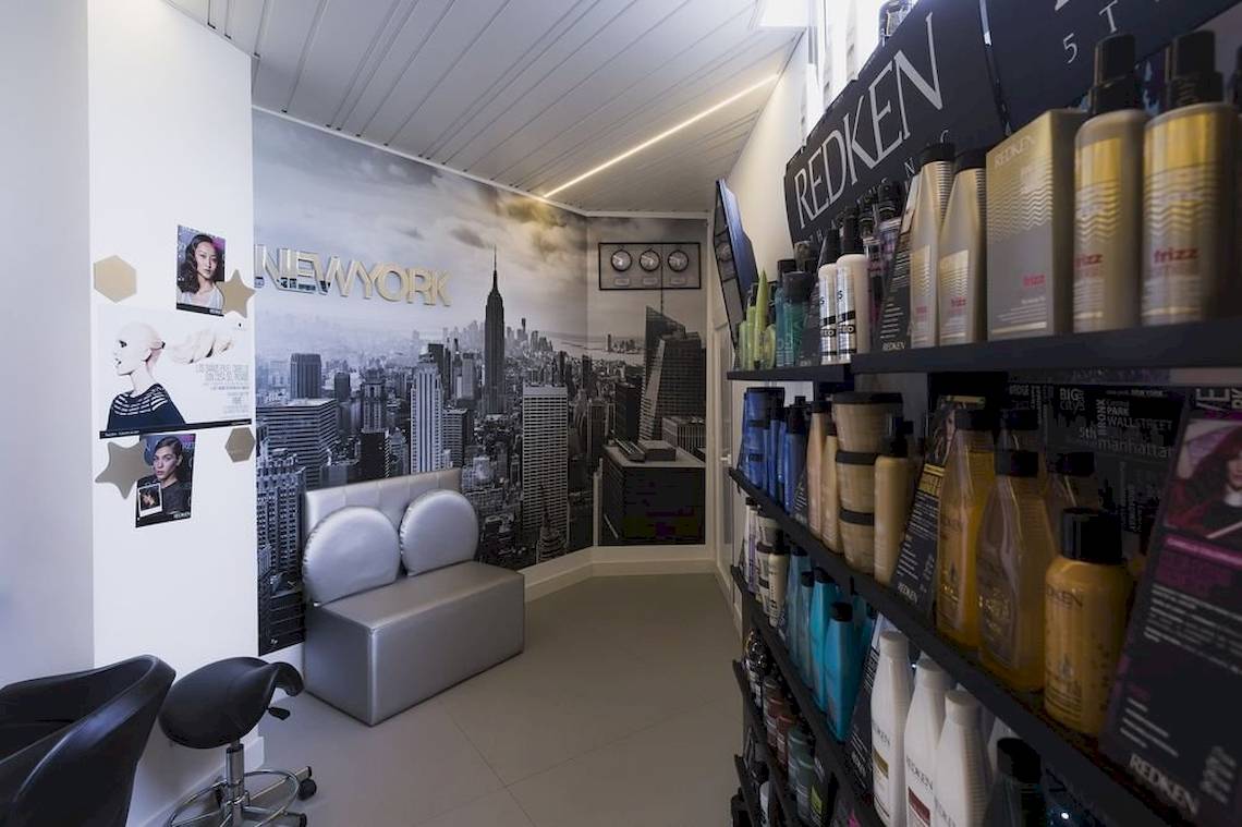 Salon mit New York Wandbild und Haarpflegeprodukten auf Regalen.