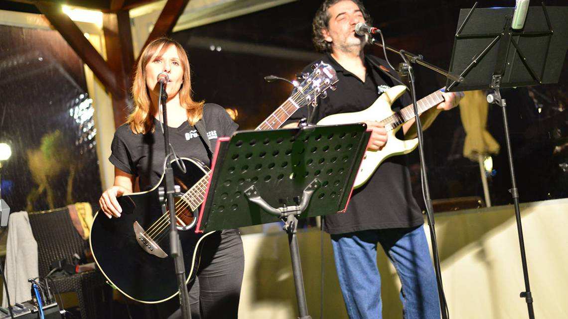 Zwei Musiker spielen Gitarren auf der Bühne des Kiani Beach Resorts.