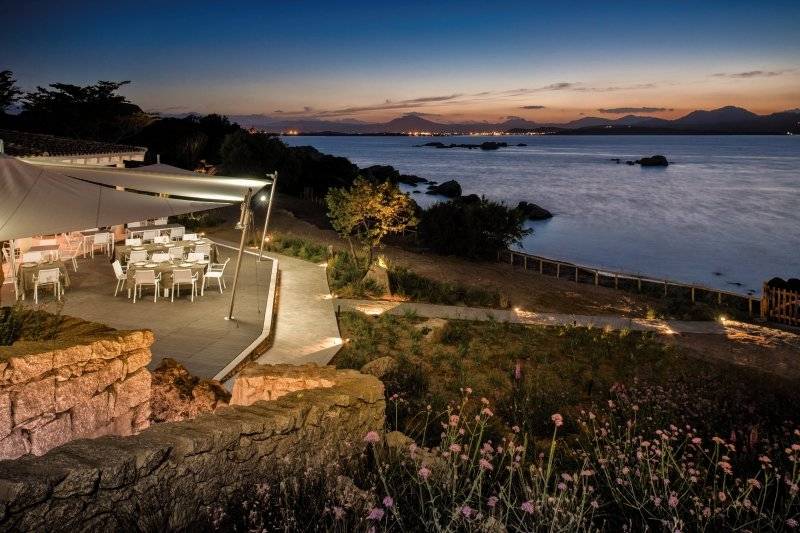 Abendessen am Strand im Hotel Cala Cuncheddi mit Blick auf das Meer und die Berge.