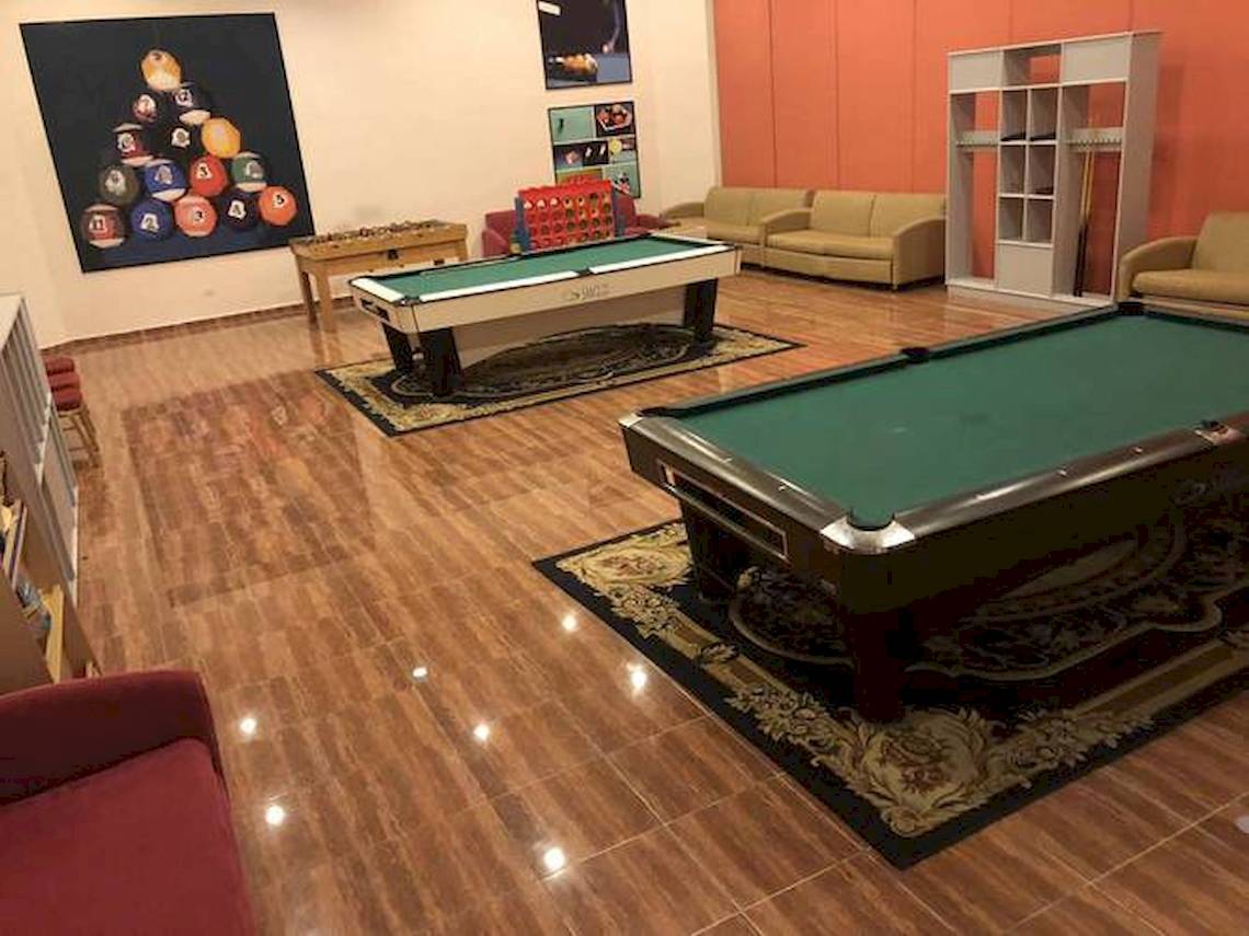 Spielzimmer im Blau Varadero Hotel mit zwei Billardtischen, Sofas und anderen Möbeln.