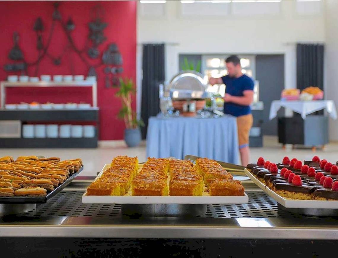 Buffet mit verschiedenen Gerichten im Allegro Agadir Hotel, darunter Kuchen und Desserts.