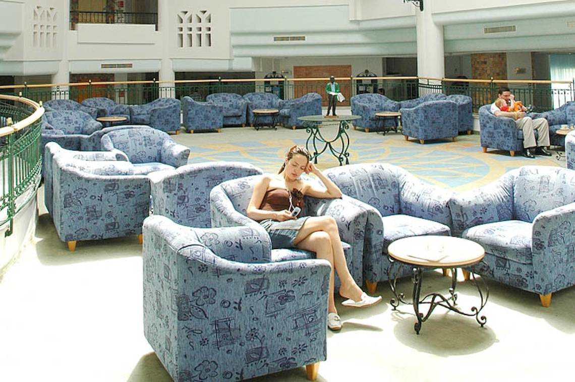 Loungebereich im El Mouradi Skanes Hotel mit vielen blauen Stühlen und Tischen.