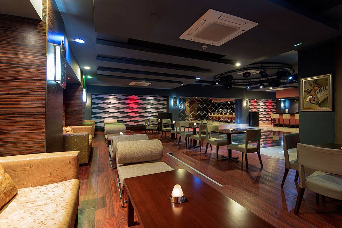 Loungebereich im Alba Queen Hotel mit Sofas, Tischen und moderner Einrichtung.