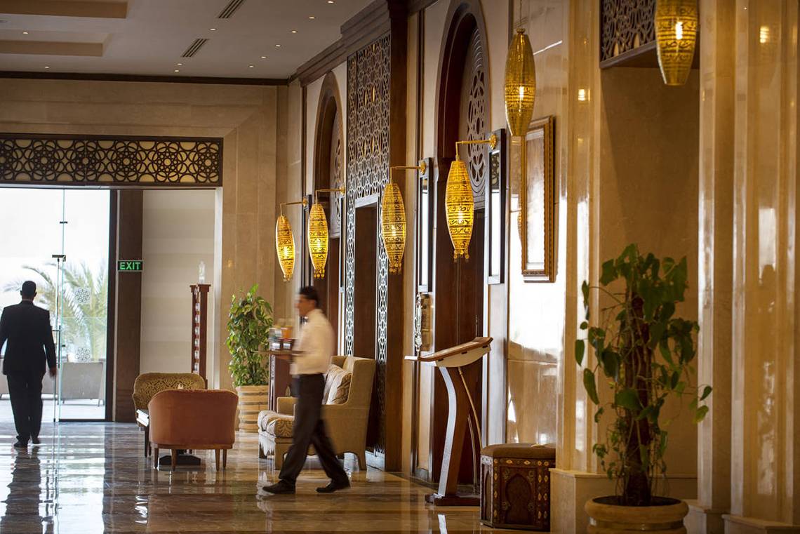Eingangsbereich im Sunrise Arabian Beach Resort mit Angestelltem und Gästen.