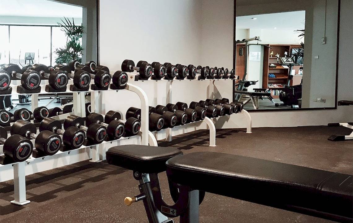 Fitnessstudio im Dewa Phuket Resort & Villas mit vielen Hanteln und Trainingsgeräten.