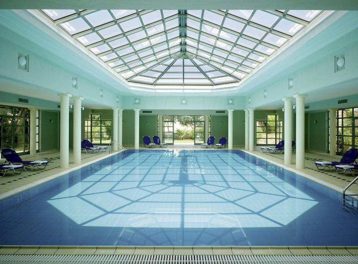 Innenpool des Kalimera Kriti Hotel & Village Resort mit blauem Wasser und geometrischem Bodenmuster