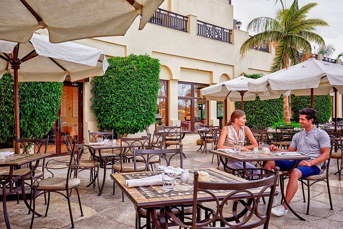 Paar sitzt draußen am Tisch im Steigenberger ALDAU Beach Hotel