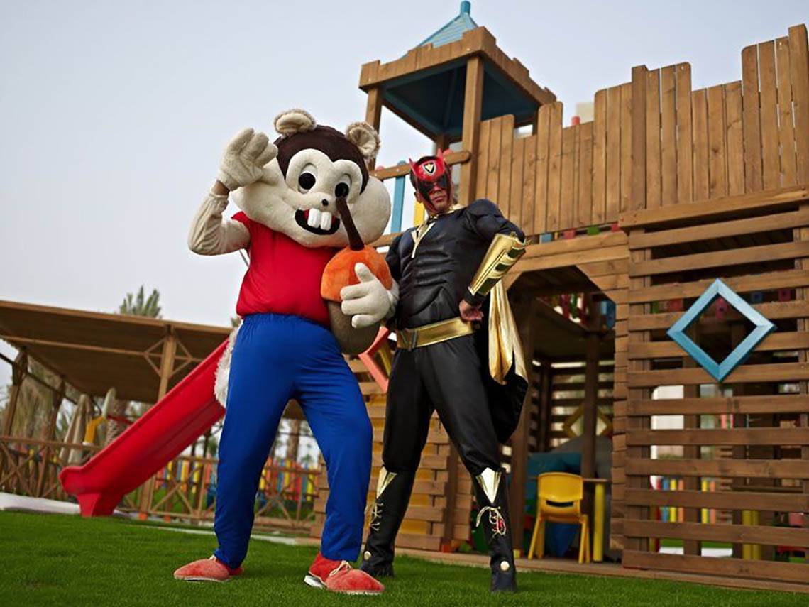 Zwei Maskottchen vor einem hölzernen Spielplatz im Rixos Hotel