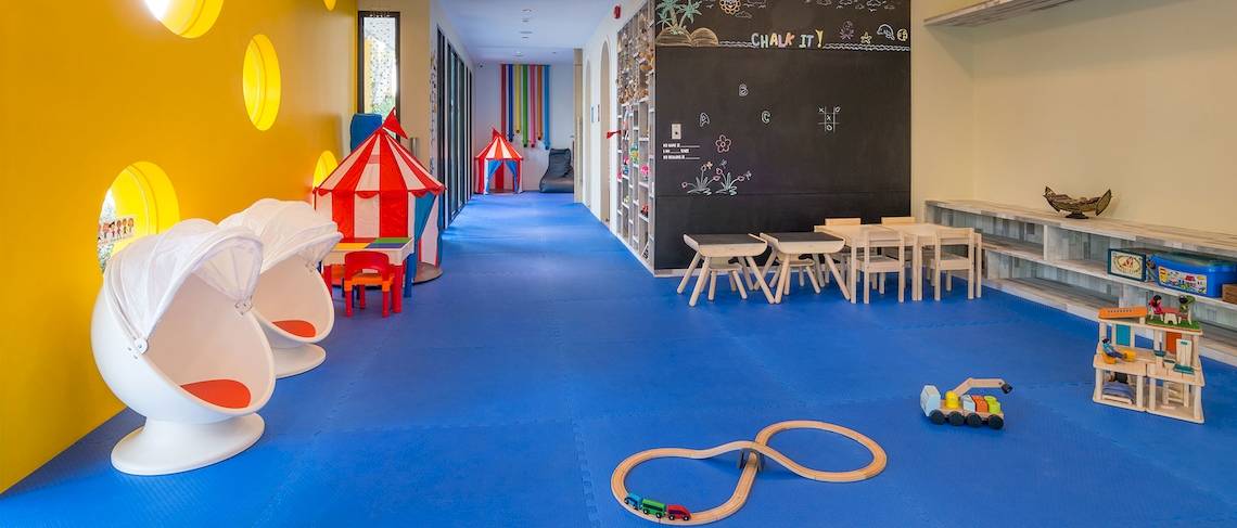 Kinderspielbereich im Dusit Thani Krabi Beach Resort mit bunten Möbeln und Spielzeug.