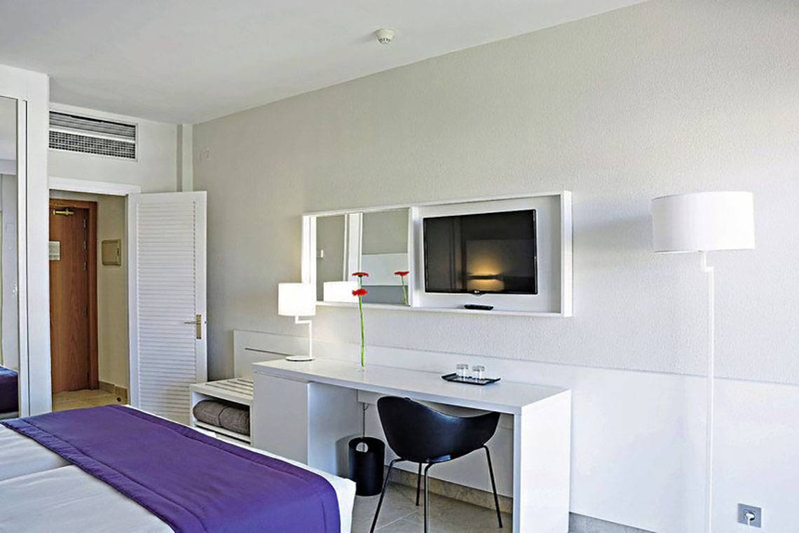 Innenansicht eines Hotelzimmers im Gran Canaria Princess Hotel mit Schreibtisch, Bett und Fernseher.