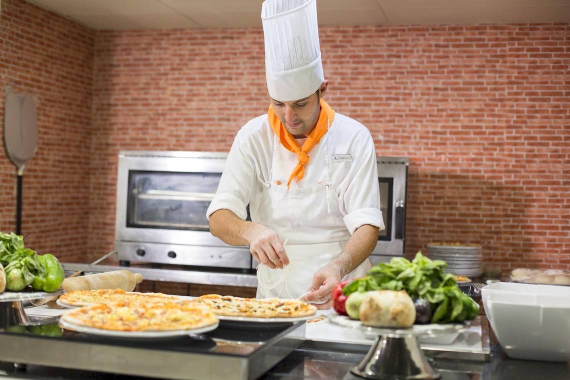Ein Koch im Hipotels La Geria bereitet Pizzas zu.