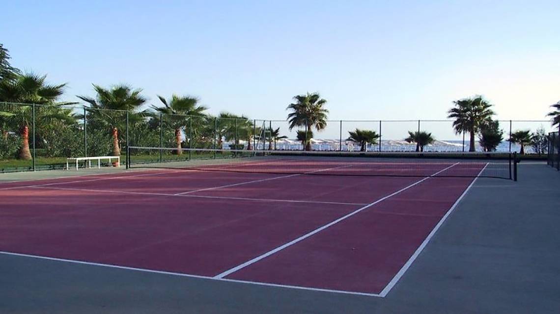 Tennisplatz im Miramare Beach Hotel mit Blick auf das Meer und Palmen