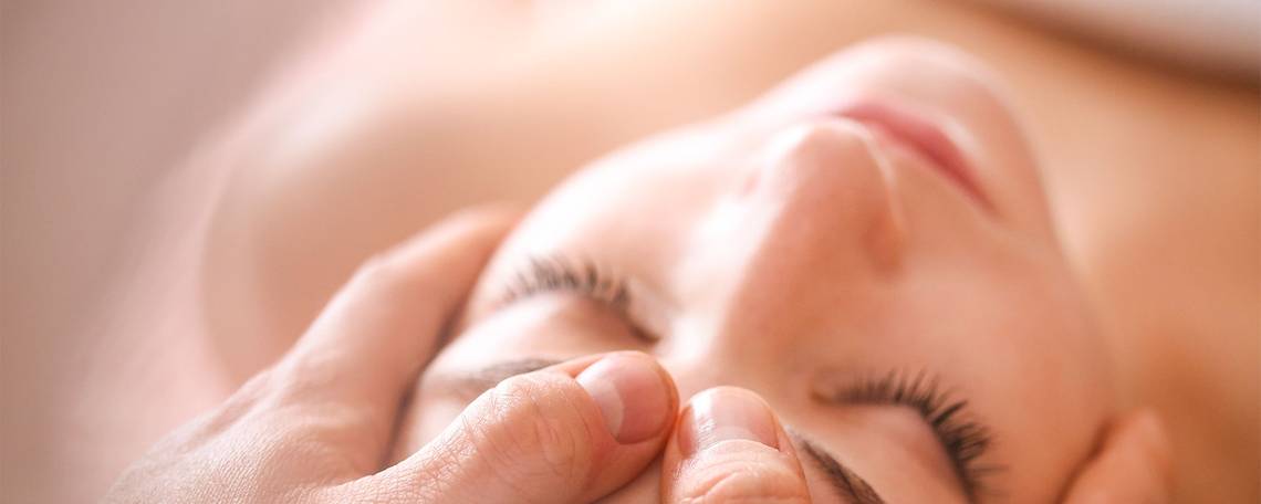 Eine Frau genießt eine Gesichtsmassage im Victoria Beachcomber Resort & Spa.