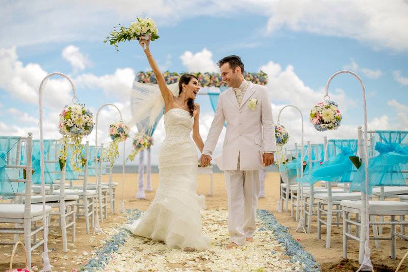 Hochzeitspaar im Mercure Resort Sanur, das auf dem Strandweg geht