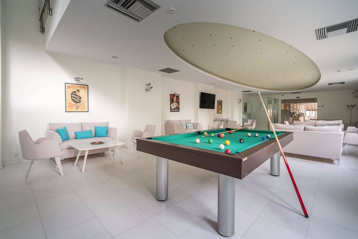 Pooltisch im Loungebereich des Galaxy Beach Resorts mit vielen Kissen und Möbeln.