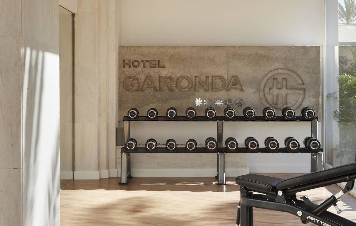 Fitnessbereich im Pure Salt Garonda Hotel mit Gewichtsbank und Hanteln.