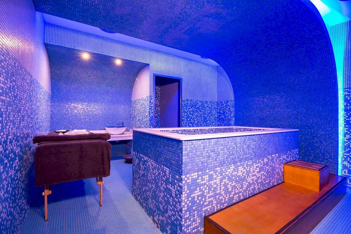 Sauna im Pegasos Deluxe Beach Hotel mit blauen Fliesen und Whirlpool