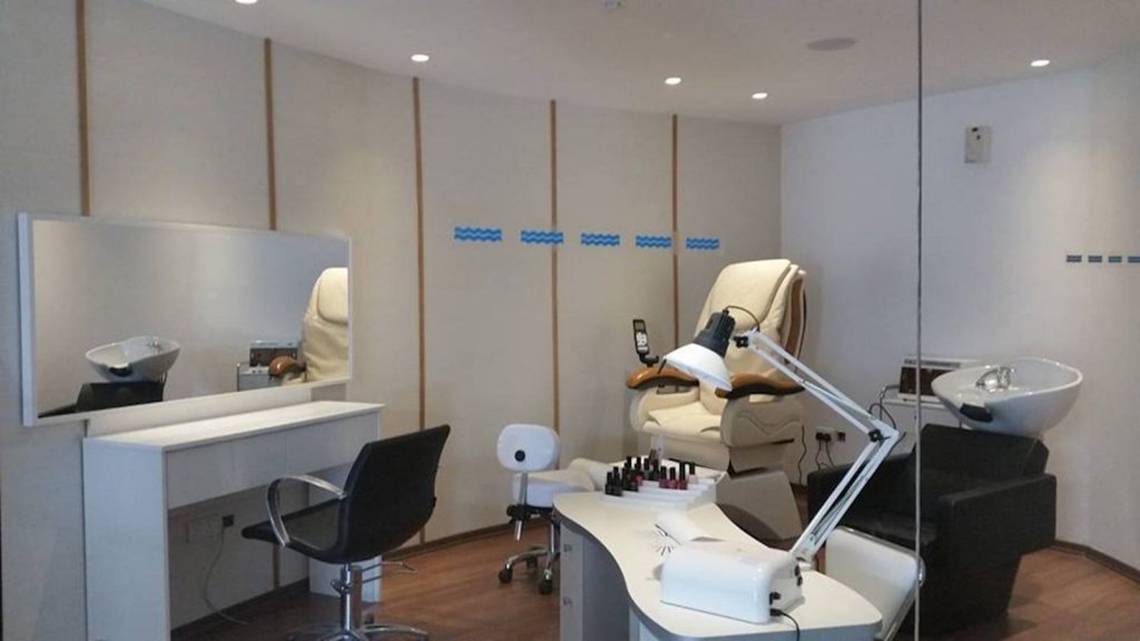 Schönheitssalon im Cavo Maris Beach Hotel mit mehreren Behandlungsräumen und Möbeln.