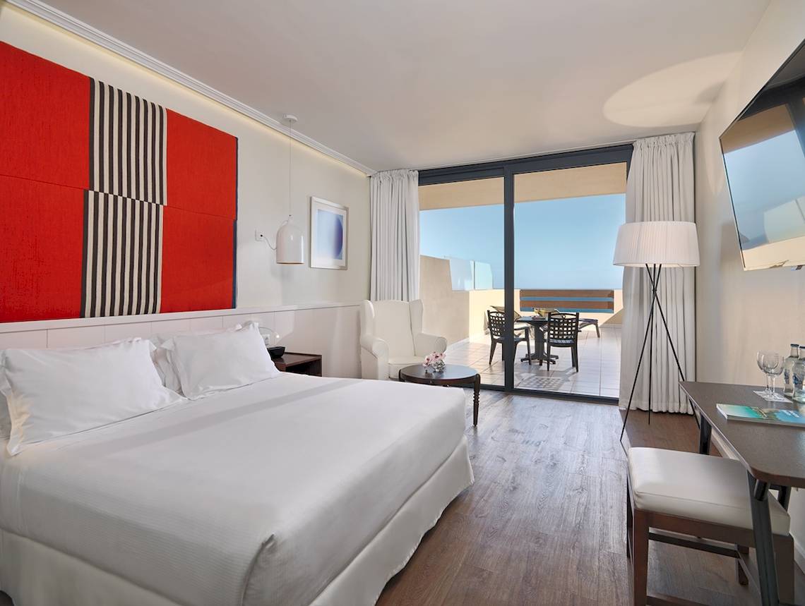 Hotelzimmer im H10 Tindaya mit Balkon, Schreibtisch und modernem Interieur.