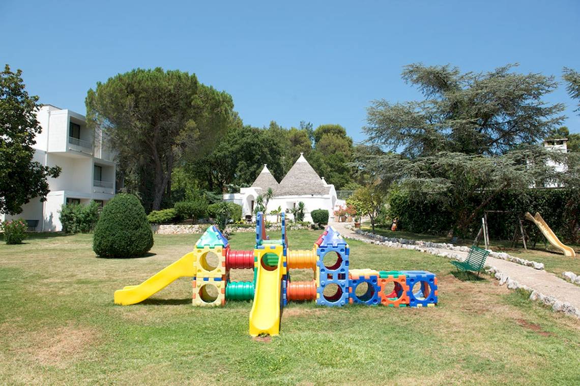 Kinderspielplatz im Hotel Sierra Silvana mit bunten Spielgeräten und einem gelben Rutschen