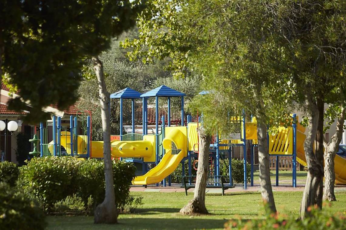 Spielplatz im Capo Di Corfu Hotel mit gelben Rutschen und blauen Überdachungen