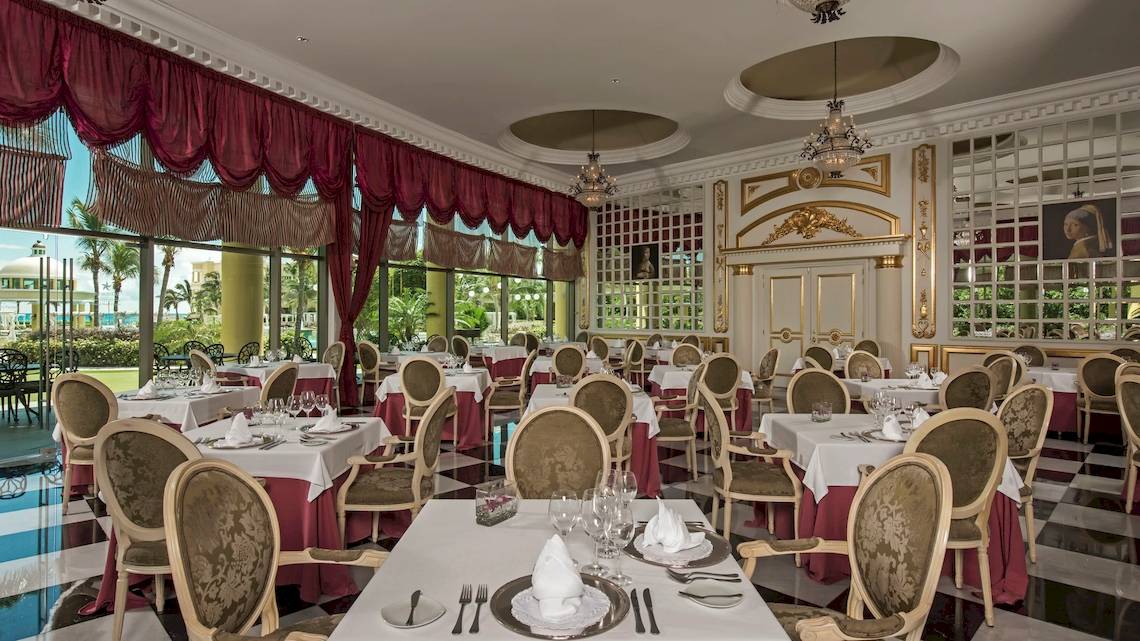 Elegantes Restaurant des Iberostar Grand Paraiso mit Tischdecken und Kerzenleuchtern.