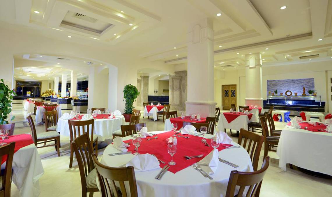 Restaurant im Charmillion Club Aqua Park mit gedeckten Tischen und Stühlen.