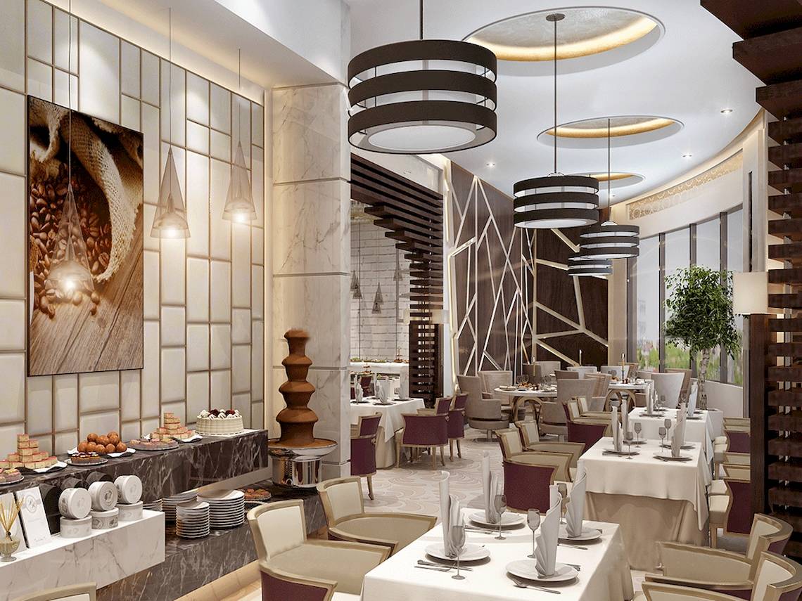 Innenansicht des Belad Bont Resorts Restaurant mit Marmorwänden, modernen Möbeln und mehreren Tischen mit Servietten und Geschirr.
