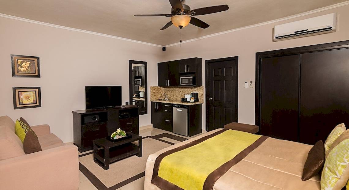 Suite im Occidental Papagayo Hotel mit Fernseher, Couch, Tisch, Klimaanlage und Küche