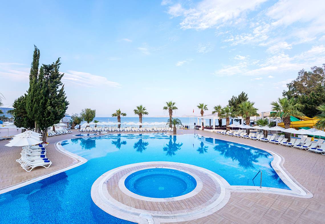 LABRANDA TMT Bodrum Hotel mit großem Swimmingpool und Sonnenliegen unter Palmen